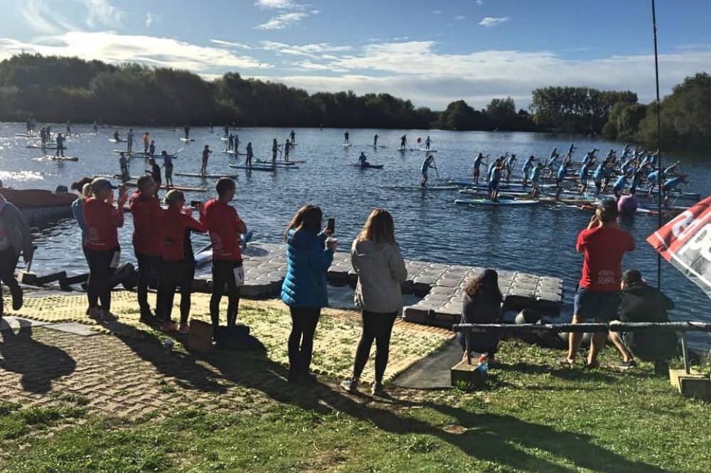 Loads of paddle boarders take to the water on a sunny day at Bray Lake in Berkshire