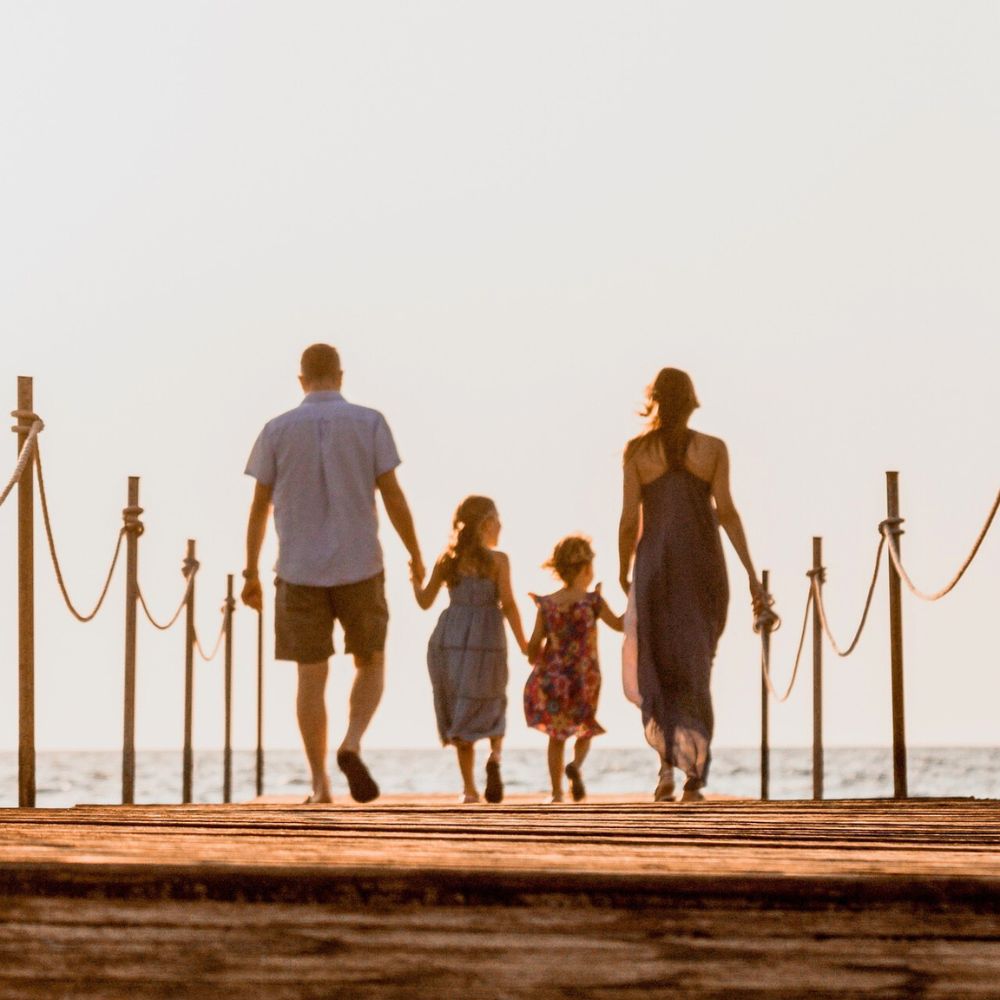 Family walking towards the seaside