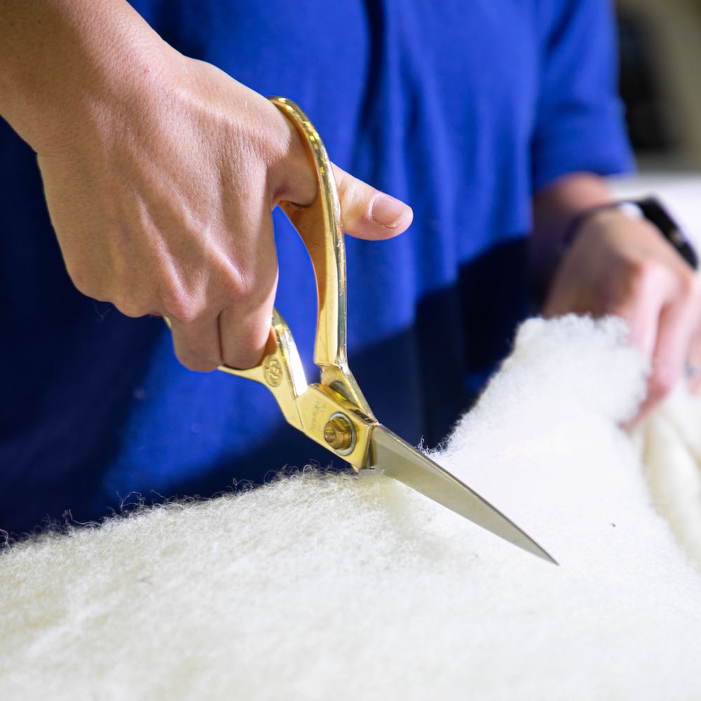 Devon Duvets cutting wool with metal scissors