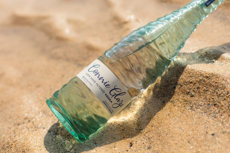 Close up of bottle of Connie Glaze Slow Sand Filtered Vodka on the sand Southwestern Distillery Cornwall