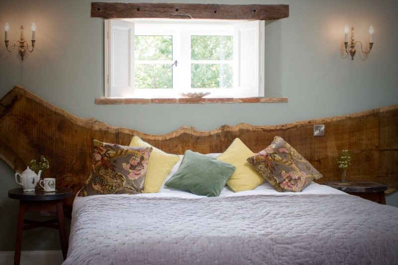 Bedroom with elm headboard at The Brisley Bell, county pub in Norfolk