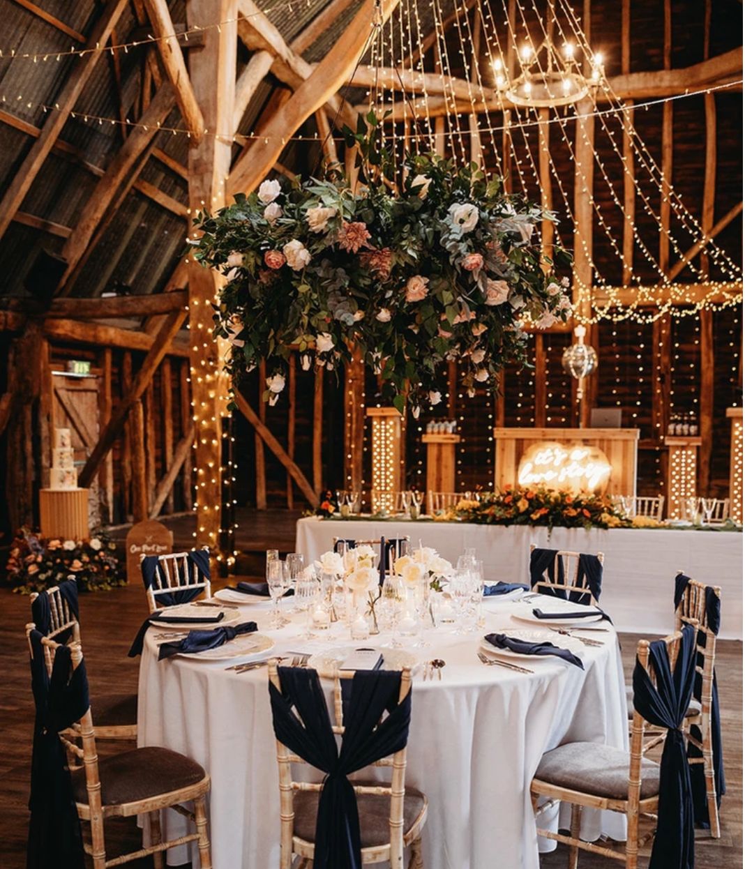 barn wedding with black drapes and flowers