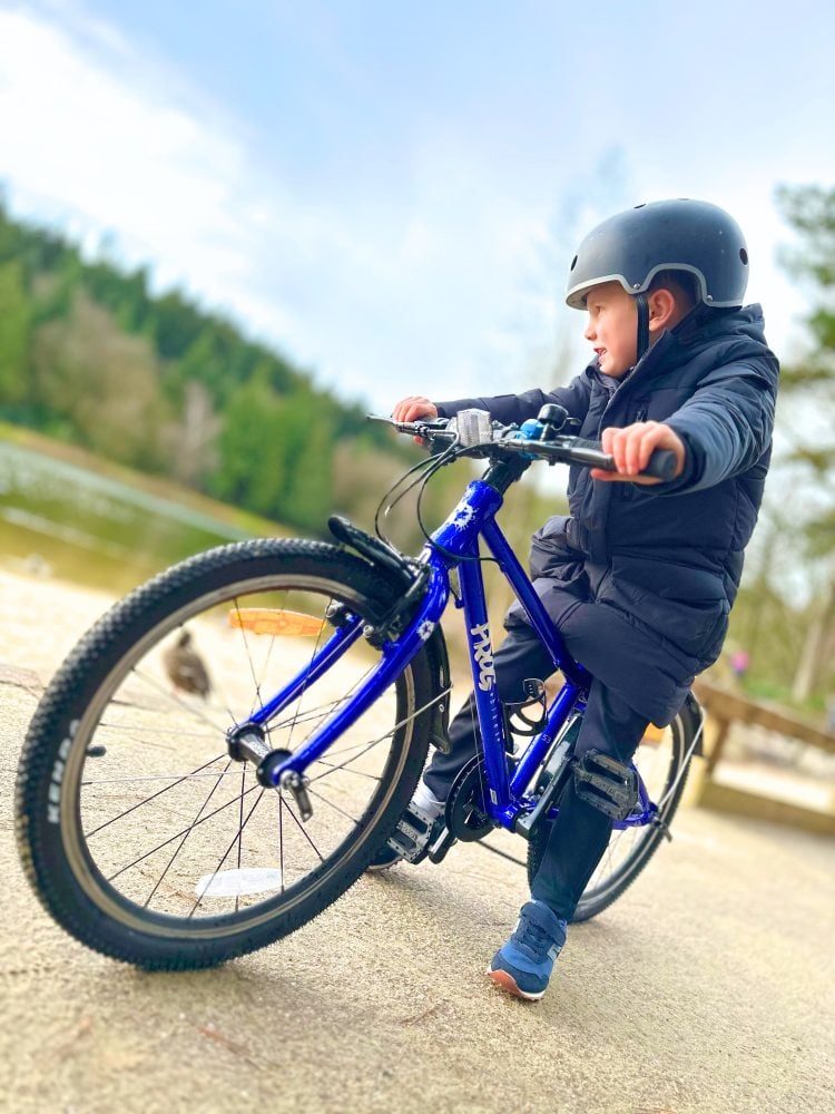 Boy on blue frog bike